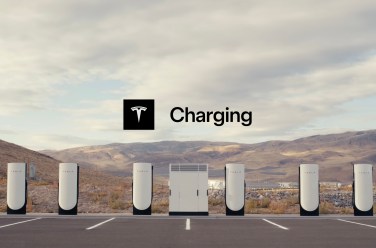 Tesla v4 supercharger station with desert background, no cars, and big white power box in the middle