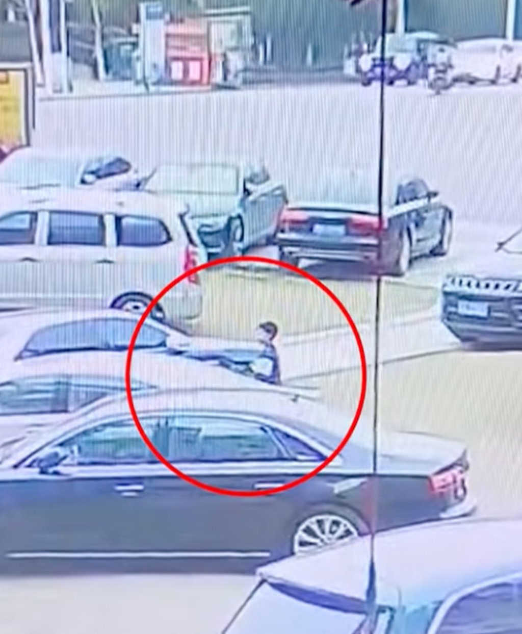 The boy can be seen standing between two parked cars moments before the blast. Photo: CCTV