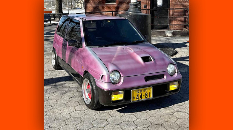 A pink Suzuki Alto Works kei car