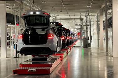 An assembly line shows Tesla Model Y vehicles.