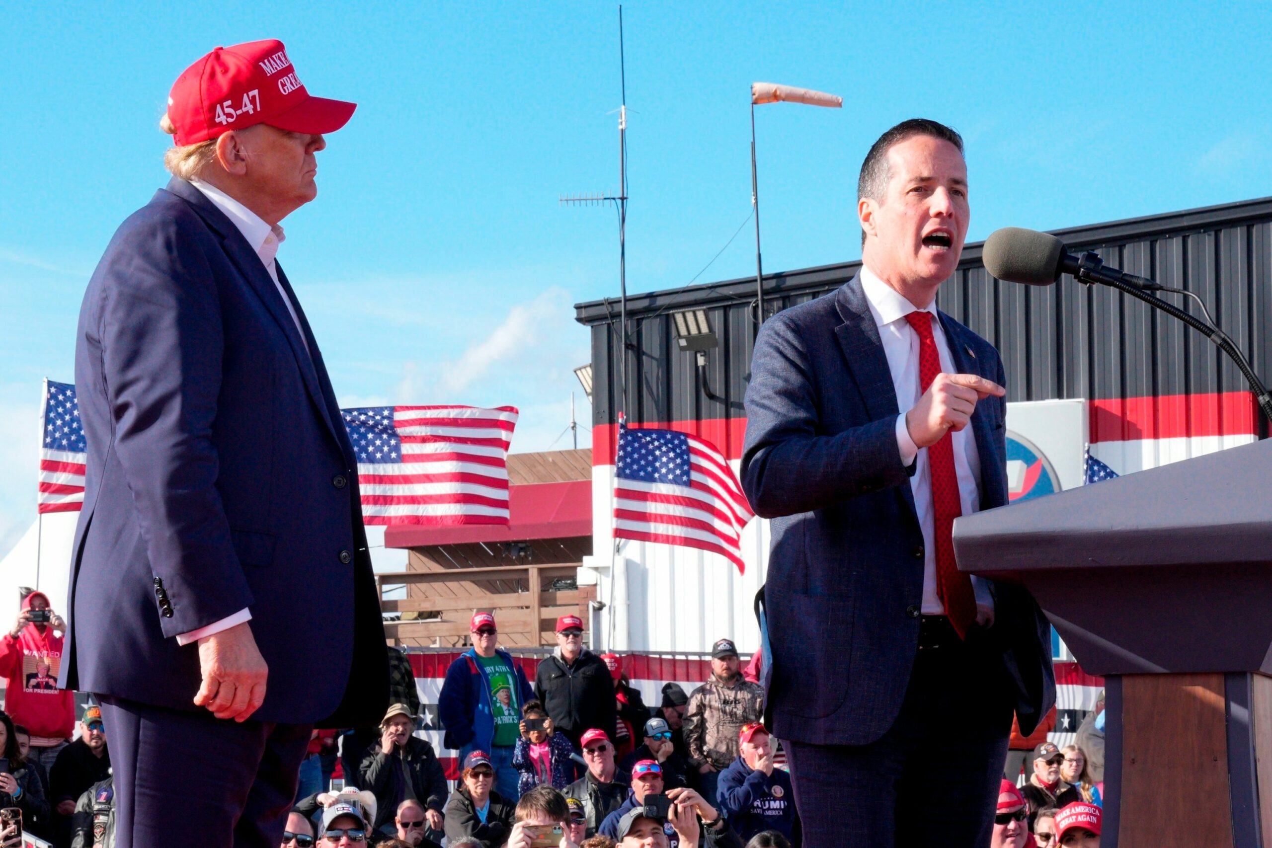 Republican presidential candidate and former President Donald Trump, left, listens as Senate candidate Bernie Moreno speaks at a campaign rally March 16, 2024, in Vandalia, Ohio.